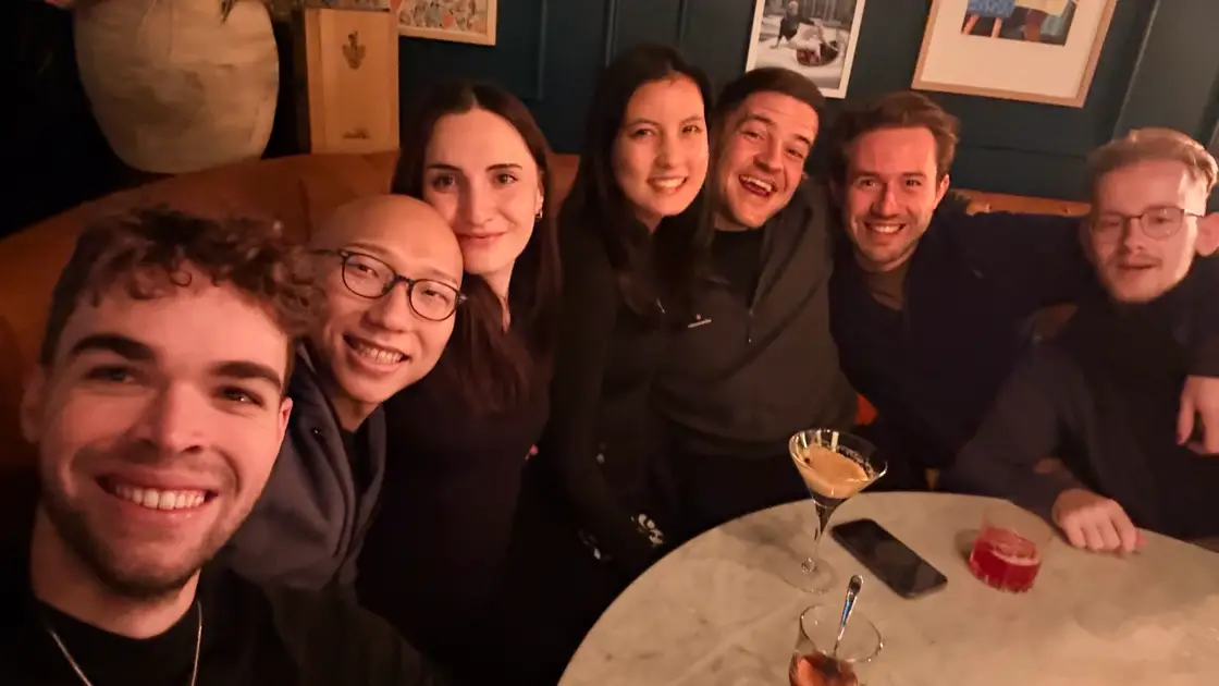 The crew laughing into the camera over New Year's Eve in Finland.